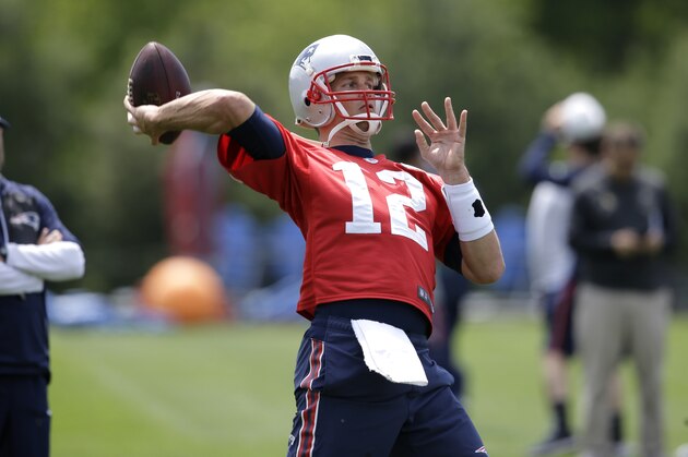 New England Patriots quarterback Tom Brady (12) winds up for a pass as offensive coordinator Josh McDaniels, left, looks on during an NFL football team practice, Thursday, June 8, 2017, in Foxborough, Mass. (AP Photo/Steven Senne)