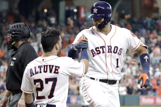 Houston Astros' Carlos Correa (1) celebrates with Jose Altuve (27) after both scored on Correa's home run against the Oakland Athletics during the sixth inning of a baseball game Thursday, June 29, 2017, in Houston. (AP Photo/David J. Phillip)