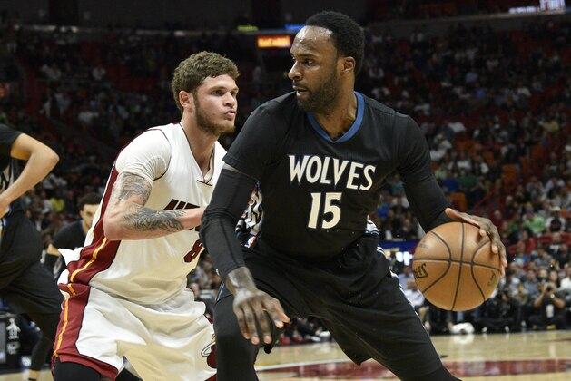 Minnesota Timberwolves' Shabazz Muhumamad, right, tries to get by Miami Heat's Tyler Johnson, left, during the first half of an NBA basketball game Friday, March 17, 2017, in Miami. (AP Photo/Gaston De Cardenas)