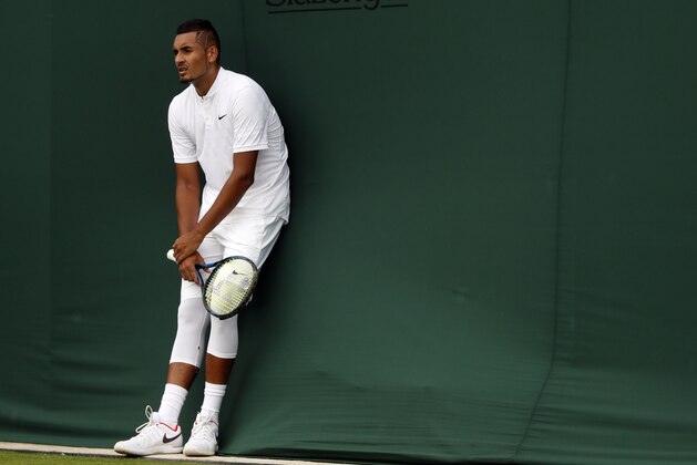 Australia's Nick Kyrgios rests during his Men's Singles Match against Pierre-Hugues Herbert of France, on the opening day at the Wimbledon Tennis Championships in London Monday, July 3, 2017. (AP Photo/Kirsty Wigglesworth)