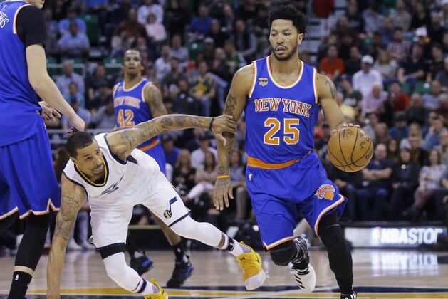 New York Knicks guard Derrick Rose (25) drives around Utah Jazz guard George Hill, left, during the first half during an NBA basketball game Wednesday, March 22, 2017, in Salt Lake City. (AP Photo/Rick Bowmer)