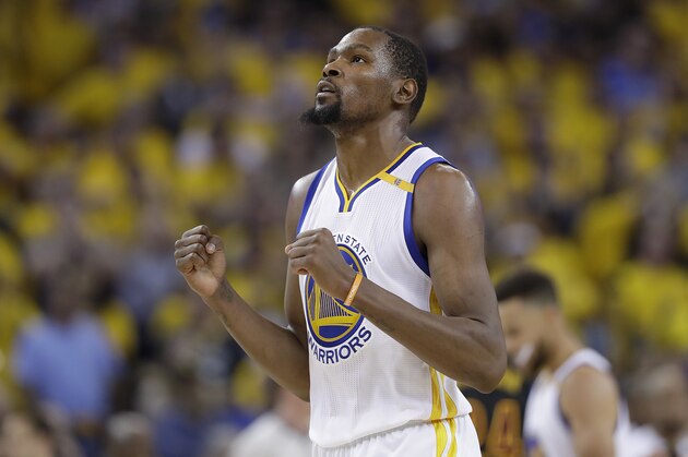 Golden State Warriors forward Kevin Durant reacts after scoring against the Cleveland Cavaliers during the second half of Game 5 of basketball's NBA Finals in Oakland, Calif., Monday, June 12, 2017. (AP Photo/Marcio Jose Sanchez)