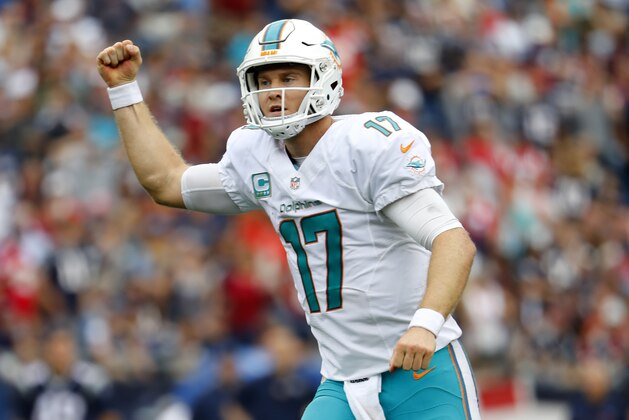 Miami Dolphins quarterback Ryan Tannehill celebrates a touchdown during a NFL football game against the New England Patriots at Gillette Stadium in Foxborough, Mass. Sunday, Sept. 18, 2016. (Winslow Townson/AP Images for Panini)