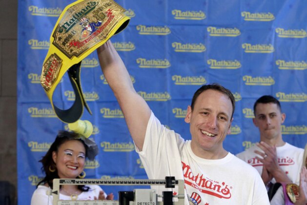 Eight-time men's champion Joey Chestnut, of San Jose, Calif., holds holds his championship belt during the weigh-in for the 2017 Nathan's Hot Dog Eating Contest, in Brooklyn Borough Hall, in New York, Monday, July 3, 2017. Chestnut weighed-in at 221.5 pounds. The current women's champ, Miki Sudo, of Las Vegas, is at right. (AP Photo/Richard Drew)