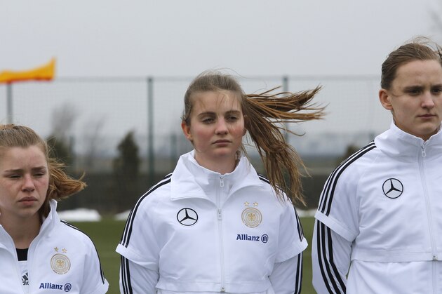 STARA PAZOVA, SERBIA - FEBRUARY 13: (L-R) Linda Dallmann Marie Christin Becker and Katharina Leiding of Germany listen national anthem before the Under-19 Women's International friendly match between Serbia and Germany on February 13, 2013 in Stara Pazova, Serbia. (Photo by Srdjan Stevanovic/Bongarts/Getty Images)