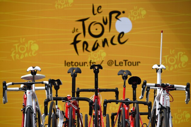 The official logo of the Tour de France is pictured behind bikes prior to the 207,5 km fourth stage of the 104th edition of the Tour de France cycling race on July 4, 2017 between Mondorf-les-Bains and Vittel. / AFP PHOTO / Lionel BONAVENTURE (Photo credit should read LIONEL BONAVENTURE/AFP/Getty Images) The official logo of the Tour de France is pictured behind bikes prior to the 207,5 km fourth stage of the 104th edition of the Tour de France cycling race on July 4, 2017 between Mondorf-les-Bains and Vittel. / AFP PHOTO / Lionel BONAVENTURE (Photo credit should read LIONEL BONAVENTURE/AFP/Getty Images)