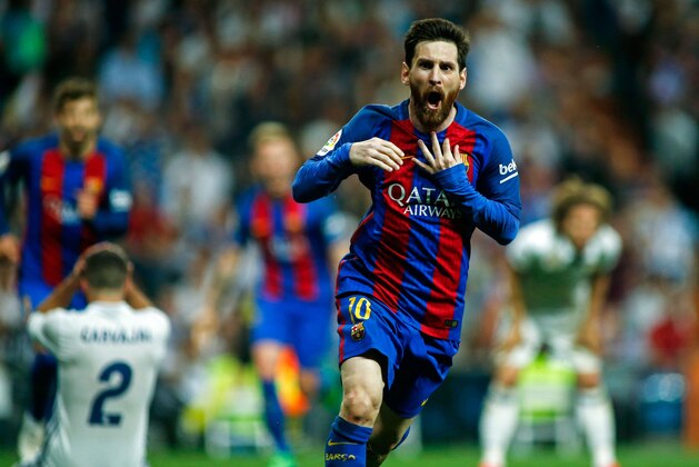Barcelona's Argentinian forward Lionel Messi celebrates after scoring during the Spanish league Clasico football match Real Madrid CF vs FC Barcelona at the Santiago Bernabeu stadium in Madrid on April 23, 2017. / AFP PHOTO / OSCAR DEL POZO        (Photo credit should read OSCAR DEL POZO/AFP/Getty Images)