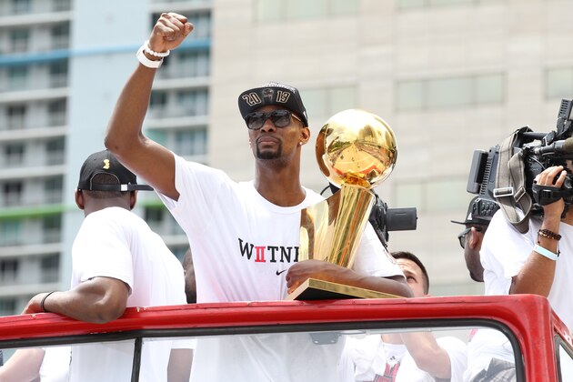 MIAMI, FL - JUNE 24: Chris Bosh #1 of the Miami Heat holds the Larry O'Brien Trophy during the NBA championship parade through downtown Miami on June 24, 2013 in Miami, Florida. NOTE TO USER: User expressly acknowledges and agrees that, by downloading and or using this photograph, User is consenting to the terms and conditions of the Getty Images License Agreement. Mandatory Copyright Notice: Copyright 2013 NBAE (Photo by Isaac Baldizon/NBAE via Getty Images)
