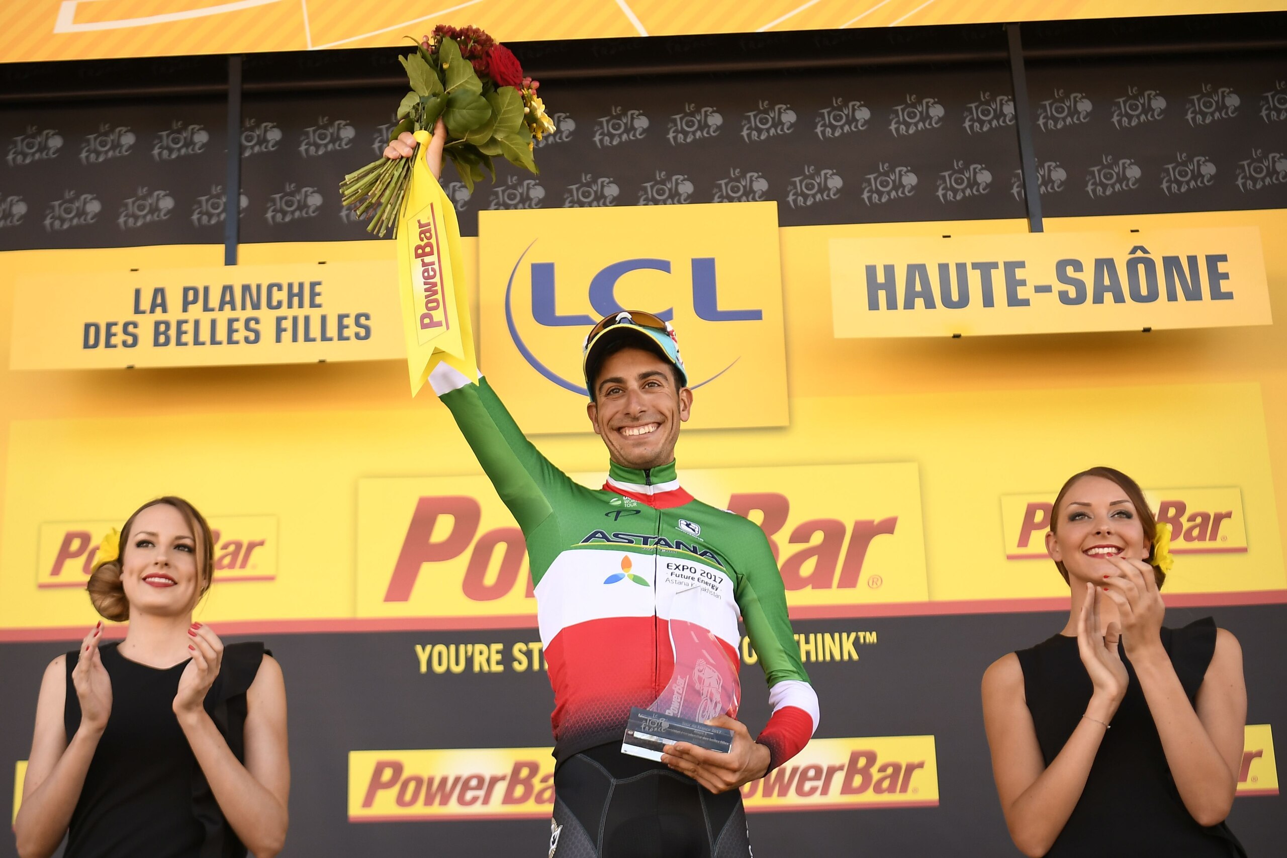 Stage winner Italy's Fabio Aru celebrates on the podium after winning the 160,5 km fifth stage of the 104th edition of the Tour de France cycling race on July 5, 2017 between Vittel and La Planche des Belles Filles. / AFP PHOTO / Lionel BONAVENTURE        (Photo credit should read LIONEL BONAVENTURE/AFP/Getty Images)