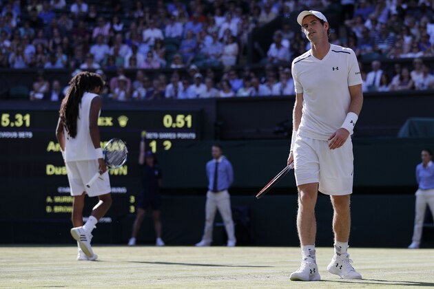 Britain's Andy Murray (R) returns to his side of the court after running to the net to return a drop shot, played by Germany's Dustin Brown during their men's singles second round match on the third day of the 2017 Wimbledon Championships at The All England Lawn Tennis Club in Wimbledon, southwest London, on July 5, 2017. / AFP PHOTO / Adrian DENNIS / RESTRICTED TO EDITORIAL USE        (Photo credit should read ADRIAN DENNIS/AFP/Getty Images)