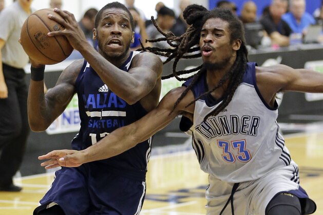 Dallas Mavericks' Dwight Buycks, left, drives to the basket against Oklahoma City Thunder's Marcus Thornton (33) during the first half of an NBA summer league basketball game, Wednesday, July 5, 2017, in Orlando, Fla. (AP Photo/John Raoux)