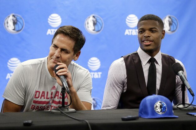 Dallas Mavericks team owner Mark Cuban, left, makes comments as he jokes with their 2017 NBA basketball first round draft selectee Dennis Smith Jr., right, during a news conference, Friday, June 23, 2017, in Dallas. (AP Photo/Tony Gutierrez)