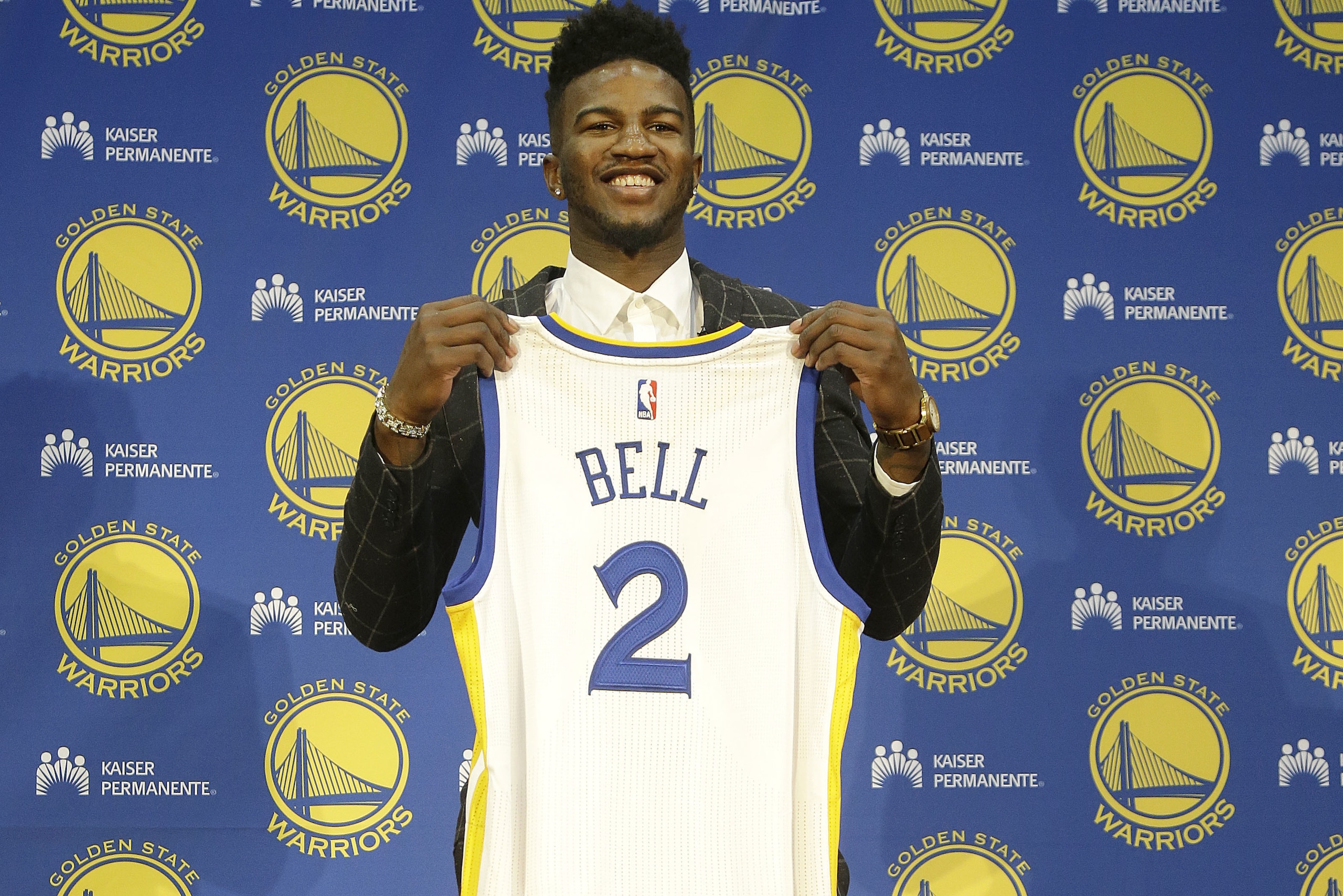 Golden State Warriors NBA basketball draft pick Jordan Bell poses for photos with a jersey at a news conference in Oakland, Calif., Friday, June 23, 2017. (AP Photo/Jeff Chiu)