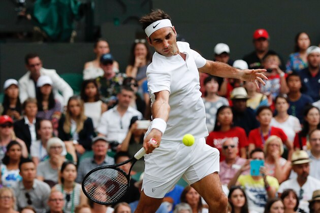 Switzerland's Roger Federer returns against Serbia's Dusan Lajovic during their men's singles second round match on the fourth day of the 2017 Wimbledon Championships at The All England Lawn Tennis Club in Wimbledon, southwest London, on July 6, 2017. / AFP PHOTO / Adrian DENNIS / RESTRICTED TO EDITORIAL USE        (Photo credit should read ADRIAN DENNIS/AFP/Getty Images)