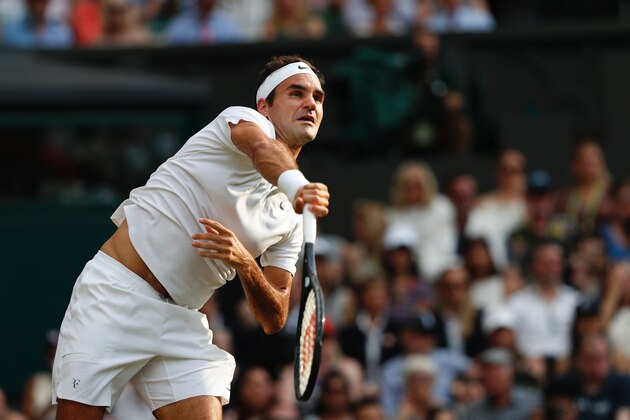 Switzerland's Roger Federer serves against Serbia's Dusan Lajovic during their men's singles second round match on the fourth day of the 2017 Wimbledon Championships at The All England Lawn Tennis Club in Wimbledon, southwest London, on July 6, 2017. / AFP PHOTO / Adrian DENNIS / RESTRICTED TO EDITORIAL USE        (Photo credit should read ADRIAN DENNIS/AFP/Getty Images)