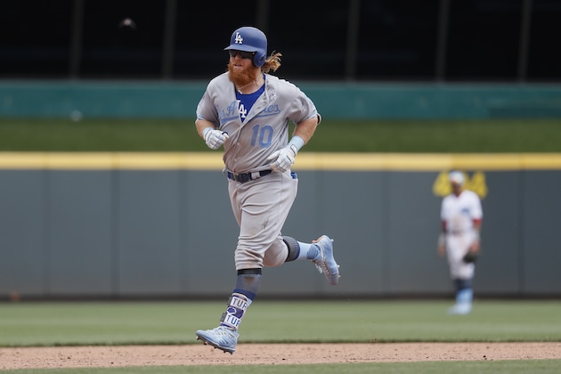 Los Angeles Dodgers' Justin Turner runs the bases after hitting a three-run home run off Cincinnati Reds relief pitcher Wandy Peralta in the sixth inning of a baseball game, Sunday, June 18, 2017, in Cincinnati. (AP Photo/John Minchillo)