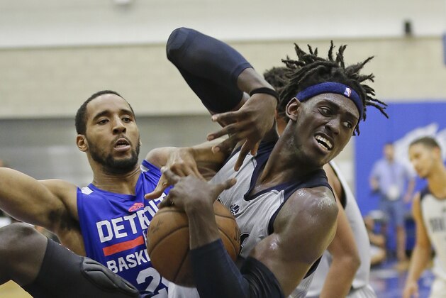 Dallas Mavericks' Johnathan Motley, right, grabs a rebound in front of Detroit Pistons' Rahlir Hollis-Jefferson during the second half of an NBA summer league basketball game, Thursday, July 6, 2017, in Orlando, Fla. (AP Photo/John Raoux)