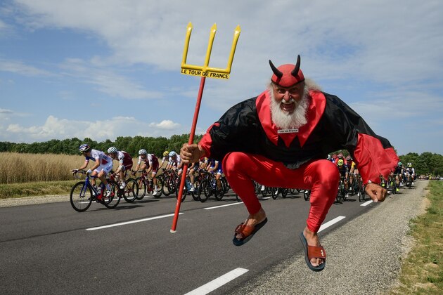 German supporter Didi Senft known as El Diablo jumps as the pack ride during the 213,5 km seventh stage of the 104th edition of the Tour de France cycling race on July 7, 2017 between Troyes and Nuits-Saint-Georges. / AFP PHOTO / PHILIPPE LOPEZ        (Photo credit should read PHILIPPE LOPEZ/AFP/Getty Images)