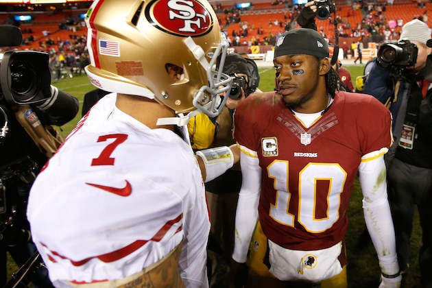 Washington Redskins quarterback Robert Griffin III and San Francisco 49ers quarterback Colin Kaepernick meet on the field after an NFL football game in Landover, Md., Monday, Nov. 25, 2013. The 49ers defeated the Redskins 27-6. (AP Photo/Alex Brandon)
