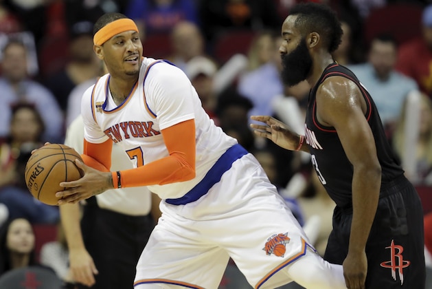 HOUSTON, TX - DECEMBER 31: Carmelo Anthony #7 of the New York Knicks controls the ball defended by James Harden #13 of the Houston Rockets in the first half at Toyota Center on December 31, 2016 in Houston, Texas. NOTE TO USER: User expressly acknowledges and agrees that, by downloading and or using this photograph, User is consenting to the terms and conditions of the Getty Images License Agreement. (Photo by Tim Warner/Getty Images)