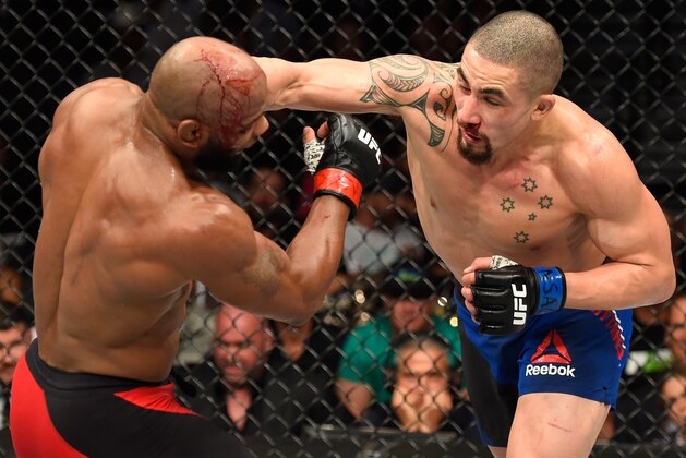 LAS VEGAS, NV - JULY 08:  (R-L) Robert Whittaker of New Zealand punches Yoel Romero of Cuba in their interim UFC middleweight championship bout during the UFC 213 event at T-Mobile Arena on July 8, 2017 in Las Vegas, Nevada.  (Photo by Josh Hedges/Zuffa LLC/Zuffa LLC via Getty Images)