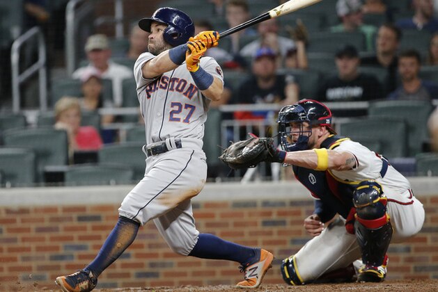 Houston Astros second baseman Jose Altuve (27) bats as Atlanta Braves catcher Tyler Flowers (25) looks on during a baseball game Wednesday, July 5, 2017, in Atlanta. (AP Photo/John Bazemore)