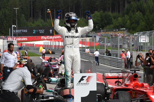 Mercedes' Finnish driver Valtteri Bottas celebrates after winning the Formula One Austria Grand Prix at the Red Bull Ring in Spielberg, on July 9, 2017. / AFP PHOTO / Andrej ISAKOVIC        (Photo credit should read ANDREJ ISAKOVIC/AFP/Getty Images)