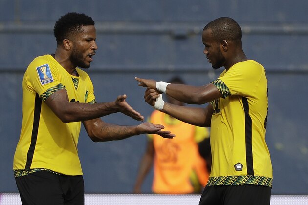 Jamaica's Romario Williams, right, greeted by Jermaine Taylor, left, after Williams scored a goal against Curacao during a CONCACAF Gold Cup soccer match in San Diego, Sunday, July 9, 2017. (AP Photo/Gregory Bull)