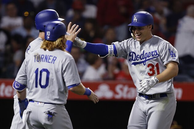 Los Angeles Dodgers' Joc Pederson, right, celebrates his three-run home run with Corey Seager and Justin Turner (10) during the sixth inning of the team's baseball game Los Angeles Angels in Anaheim, Calif., Thursday, June 29, 2017. (AP Photo/Alex Gallardo)