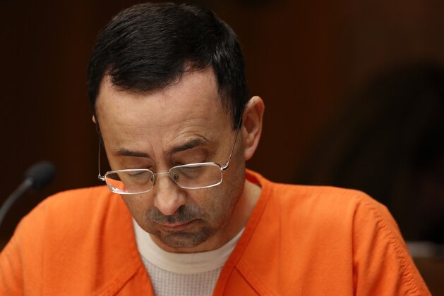 Former Michigan State University and USA Gymnastics doctor Larry Nassar is seen in the 55th District Court where Judge Donald Allen Jr. bound him over on June 23, 2017 in Mason, Michigan to stand trial on 12 counts of first-degree criminal sexual conduct. / AFP PHOTO / JEFF KOWALSKY        (Photo credit should read JEFF KOWALSKY/AFP/Getty Images)