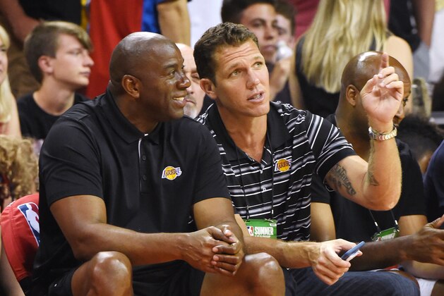 LAS VEGAS, NV - JULY 07:  Los Angeles Lakers president of basketball operations Earvin 'Magic' Johnson (L) and head coach Luke Walton of the Lakers talk during a 2017 Summer League game between the Lakers and the Los Angeles Clippers at the Thomas & Mack Center on July 7, 2017 in Las Vegas, Nevada. The Clippers won 96-93 in overtime. NOTE TO USER: User expressly acknowledges and agrees that, by downloading and or using this photograph, User is consenting to the terms and conditions of the Getty Images License Agreement.  (Photo by Ethan Miller/Getty Images)