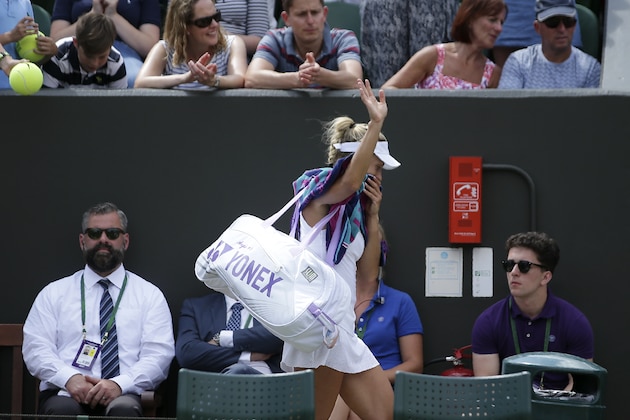Germany's Angelique Kerber leaves the court after losing against Spain's Garbine Muguruza during their women's singles fourth round match on the seventh day of the 2017 Wimbledon Championships at The All England Lawn Tennis Club in Wimbledon, southwest London, on July 10, 2017. / AFP PHOTO / Daniel LEAL-OLIVAS / RESTRICTED TO EDITORIAL USE        (Photo credit should read DANIEL LEAL-OLIVAS/AFP/Getty Images)