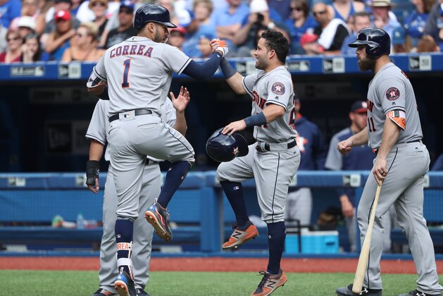 TORONTO, ON - JULY 9: Carlos Correa #1 of the Houston Astros is congratulated by Jose Altuve #27 after hitting a three-run home run in the seventh inning during MLB game action against the Toronto Blue Jays at Rogers Centre on July 9, 2017 in Toronto, Canada. (Photo by Tom Szczerbowski/Getty Images)