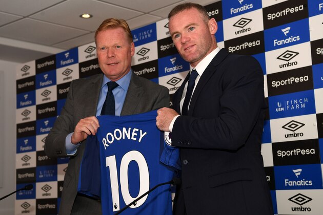 Everton's new signing, English striker Wayne Rooney (R) poses for a photograph with his new club shirt, held by Everton's Dutch manager Ronald Koeman (L) during a press conference at Goodison Park in Liverpool on July 10, 2017, following Rooney's move to Everton from Manchester United.
Rooney, whose move comes after United announced they had agreed terms with Everton over buying striker Romelu Lukaku, will hope the switch revives his international career. / AFP PHOTO / Paul ELLIS (Photo credit should read PAUL ELLIS/AFP/Getty Images) Everton's new signing, English striker Wayne Rooney (R) poses for a photograph with his new club shirt, held by Everton's Dutch manager Ronald Koeman (L) during a press conference at Goodison Park in Liverpool on July 10, 2017, following Rooney's move to Everton from Manchester United.
Rooney, whose move comes after United announced they had agreed terms with Everton over buying striker Romelu Lukaku, will hope the switch revives his international career. / AFP PHOTO / Paul ELLIS (Photo credit should read PAUL ELLIS/AFP/Getty Images)