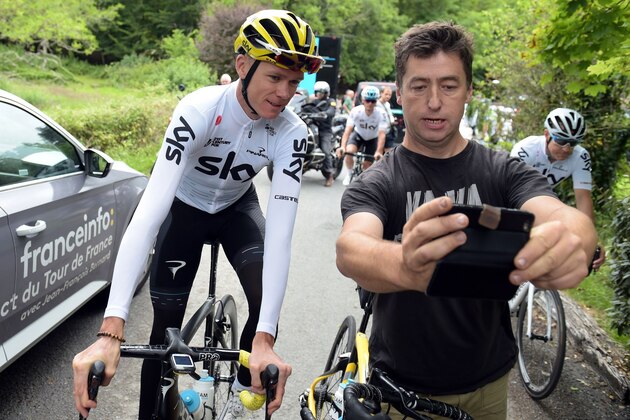 Great Britain's Christopher Froome (L) of Team Sky poses for a picture with a fan as he gets ready for a training session with members of his team during the second day off of the 104th edition of the Tour de France cycling race on July 10, 2017 in Trelissac, near Perigueux, central France. / AFP PHOTO / NICOLAS TUCAT (Photo credit should read NICOLAS TUCAT/AFP/Getty Images) Great Britain's Christopher Froome (L) of Team Sky poses for a picture with a fan as he gets ready for a training session with members of his team during the second day off of the 104th edition of the Tour de France cycling race on July 10, 2017 in Trelissac, near Perigueux, central France. / AFP PHOTO / NICOLAS TUCAT (Photo credit should read NICOLAS TUCAT/AFP/Getty Images)