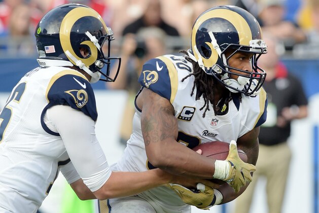 Los Angeles Rams running back Todd Gurly (30) takes a handoff from quarterback Jared Goff (16) in the third quarter of a game against the Atlanta Falcons played at the Los Angeles Memorial Coliseum in Los Angeles on Sunday, December 11, 2016. (AP Photo/John Cordes)