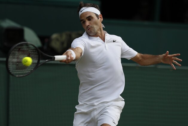 Switzerland's Roger Federer returns to Bulgaria's Grigor Dimitrov during their Men's Singles Match on day seven at the Wimbledon Tennis Championships in London Monday, July 10, 2017. (AP Photo/Kirsty Wigglesworth)