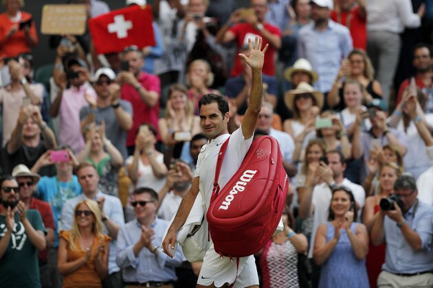 Switzerland's Roger Federer waves as he leaves the court after winning against Bulgaria's Grigor Dimitrov during their men's singles fourth round match on the seventh day of the 2017 Wimbledon Championships at The All England Lawn Tennis Club in Wimbledon, southwest London, on July 10, 2017.
Federer won the match 6-4, 6-2, 6-4. / AFP PHOTO / Adrian DENNIS / RESTRICTED TO EDITORIAL USE        (Photo credit should read ADRIAN DENNIS/AFP/Getty Images)