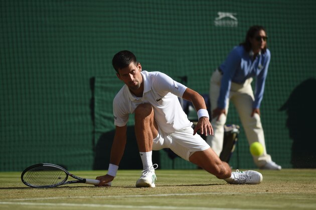 Serbia's Novak Djokovic slips over as he tries to return against Latvia's Ernests Gulbis during their men's singles third round match on the sixth day of the 2017 Wimbledon Championships at The All England Lawn Tennis Club in Wimbledon, southwest London, on July 8, 2017. / AFP PHOTO / Oli SCARFF / RESTRICTED TO EDITORIAL USE        (Photo credit should read OLI SCARFF/AFP/Getty Images)