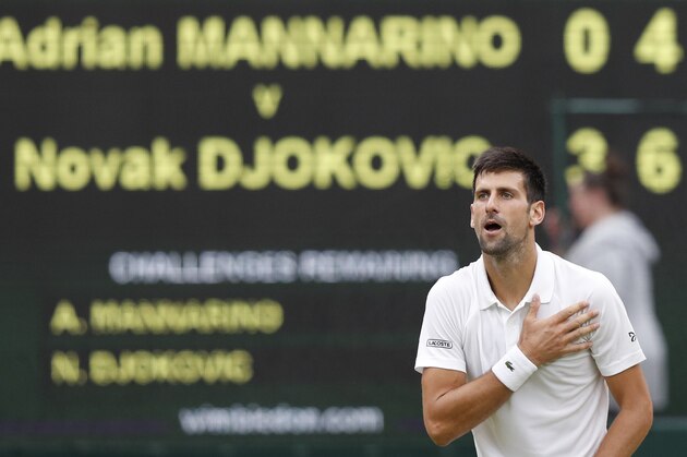 Serbia's Novak Djokovic gestures to the crowd after beating France's Adrian Mannarino during their men's singles fourth round match on the eighth day of the 2017 Wimbledon Championships at The All England Lawn Tennis Club in Wimbledon, southwest London, on July 11, 2017.
Djokovic won the match 6-2, 7-6, 6-4. / AFP PHOTO / Adrian DENNIS / RESTRICTED TO EDITORIAL USE        (Photo credit should read ADRIAN DENNIS/AFP/Getty Images)