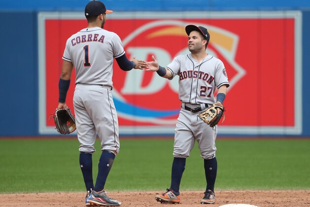 TORONTO, ON - JULY 9: Carlos Correa #1 of the Houston Astros celebrates their victory with Jose Altuve #27 during MLB game action against the Toronto Blue Jays at Rogers Centre on July 9, 2017 in Toronto, Canada. (Photo by Tom Szczerbowski/Getty Images)