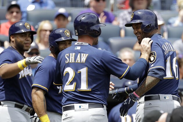 Milwaukee Brewers' Domingo Santana, far right, is congratulated by teammates after hitting a three-run home run against New York Yankees starting pitcher Luis Severino during the first inning of an interleague baseball game, Saturday, July 8, 2017, at Yankee Stadium in New York. (AP Photo/Julio Cortez)