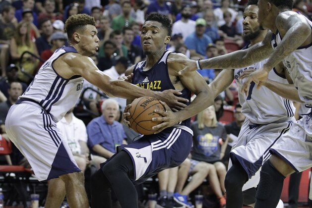 Utah Jazz's Donovan Mitchell drives around Memphis Grizzlies' Wade Baldwin IV, left, during the second half of an NBA summer league basketball game, Tuesday, July 11, 2017, in Las Vegas. (AP Photo/John Locher)