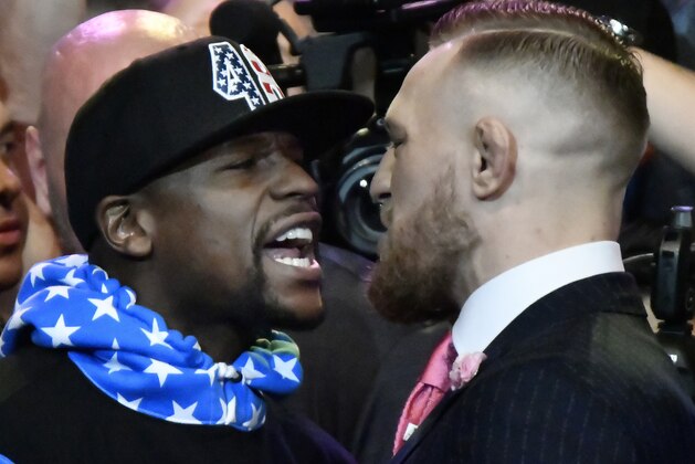 Floyd Mayweather Jr. (L) faces off for the first time with UFC fighter Conor McGregor during a press call at the Staples Center in  Los Angeles, California on July 11, 2017.
The two will fight August 26th in Las Vegas, Nevada. / AFP PHOTO / Gene Blevins        (Photo credit should read GENE BLEVINS/AFP/Getty Images)