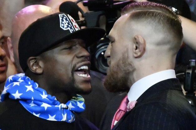 Floyd Mayweather Jr. (L) faces off for the first time with UFC fighter Conor McGregor during a press call at the Staples Center in Los Angeles, California on July 11, 2017.
The two will fight August 26th in Las Vegas, Nevada. / AFP PHOTO / Gene Blevins (Photo credit should read GENE BLEVINS/AFP/Getty Images) Floyd Mayweather Jr. (L) faces off for the first time with UFC fighter Conor McGregor during a press call at the Staples Center in Los Angeles, California on July 11, 2017.
The two will fight August 26th in Las Vegas, Nevada. / AFP PHOTO / Gene Blevins (Photo credit should read GENE BLEVINS/AFP/Getty Images)