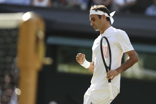Switzerland's Roger Federer celebrates winning a point against Canada's Milos Raonic during their men's singles quarter-final match on the ninth day of the 2017 Wimbledon Championships at The All England Lawn Tennis Club in Wimbledon, southwest London, on July 12, 2017. / AFP PHOTO / Daniel LEAL-OLIVAS / RESTRICTED TO EDITORIAL USE        (Photo credit should read DANIEL LEAL-OLIVAS/AFP/Getty Images)
