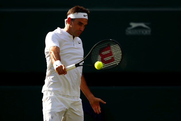 LONDON, ENGLAND - JULY 12:  Roger Federer of Switzerland plays a backhand during the Gentlemen's Singles quarter final match against Milos Raonic of Canada on day nine of the Wimbledon Lawn Tennis Championships at the All England Lawn Tennis and Croquet Club on July 12, 2017 in London, England.  (Photo by Clive Brunskill/Getty Images)