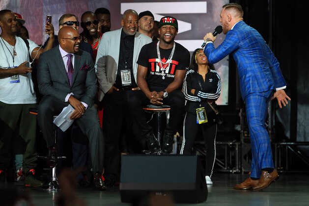 TORONTO, ON - JULY 12:   Conor McGregor speaks to Floyd Mayweather Jr. during the Floyd Mayweather Jr. v Conor McGregor World Press Tour at Budweiser Stage on July 12, 2017 in Toronto, Canada.  (Photo by Vaughn Ridley/Getty Images)