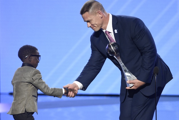 John Cena, right, presents New Orleans Saints superfan Jarrius