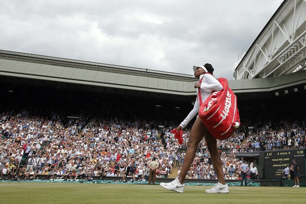 Venus Williams of the United States walks on court to play Britain's Johanna Konta in their Women's Singles semifinal match on day nine at the Wimbledon Tennis Championships in London Thursday July 13, 2017. (Andrew Couldridge/Pool Photo via AP)